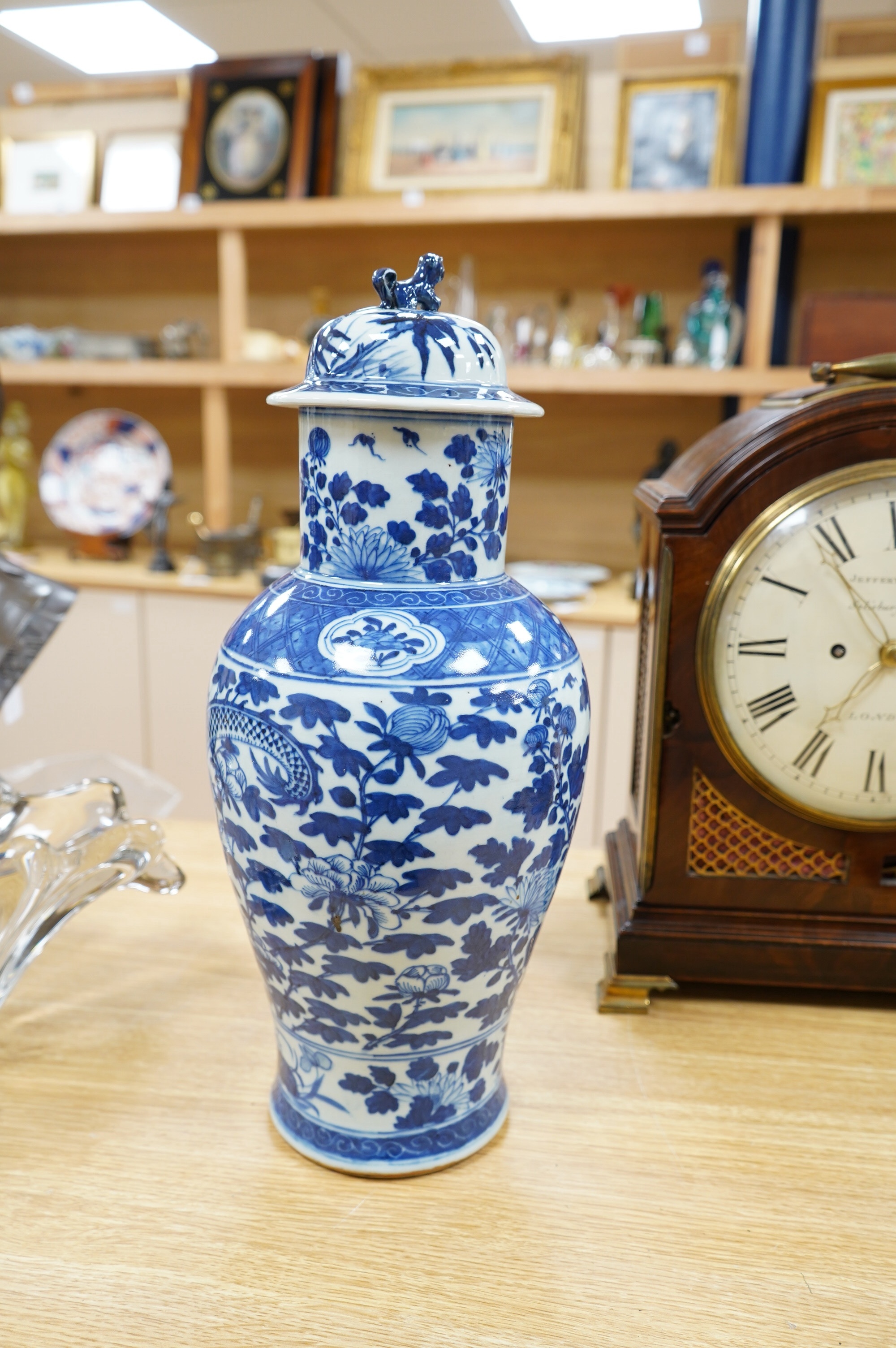 An early 20th century Chinese blue and white dragon vase and cover, 42cm high. Condition - crack and chip from rim of vase down the neck